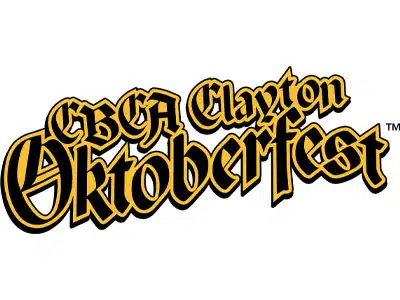 Logo for CBCA Clayton Oktoberfest featuring bold, stylized text in gold and black colors. The design prominently displays 'CBCA Clayton' above 'Oktoberfest' in an ornate font, conveying a festive theme associated with the event.